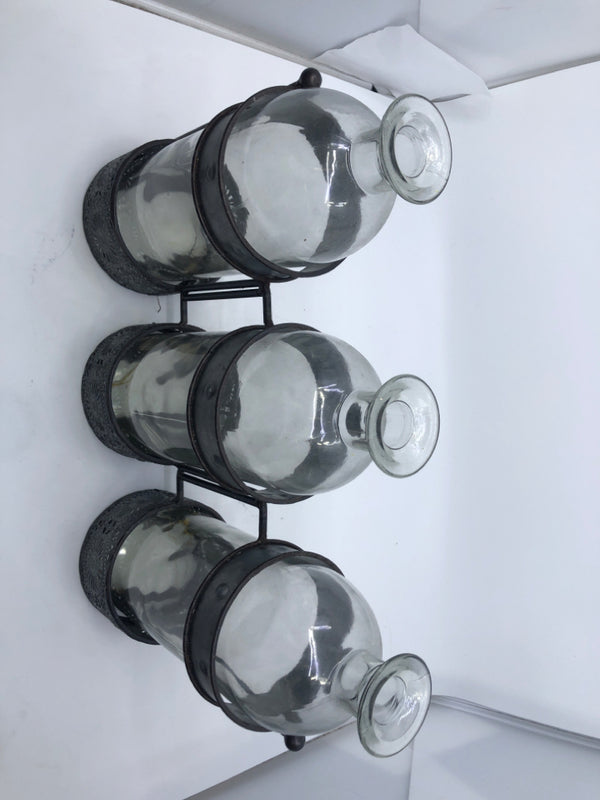 3 GLASS BOTTLE IN GALVANIZED HOLDER.