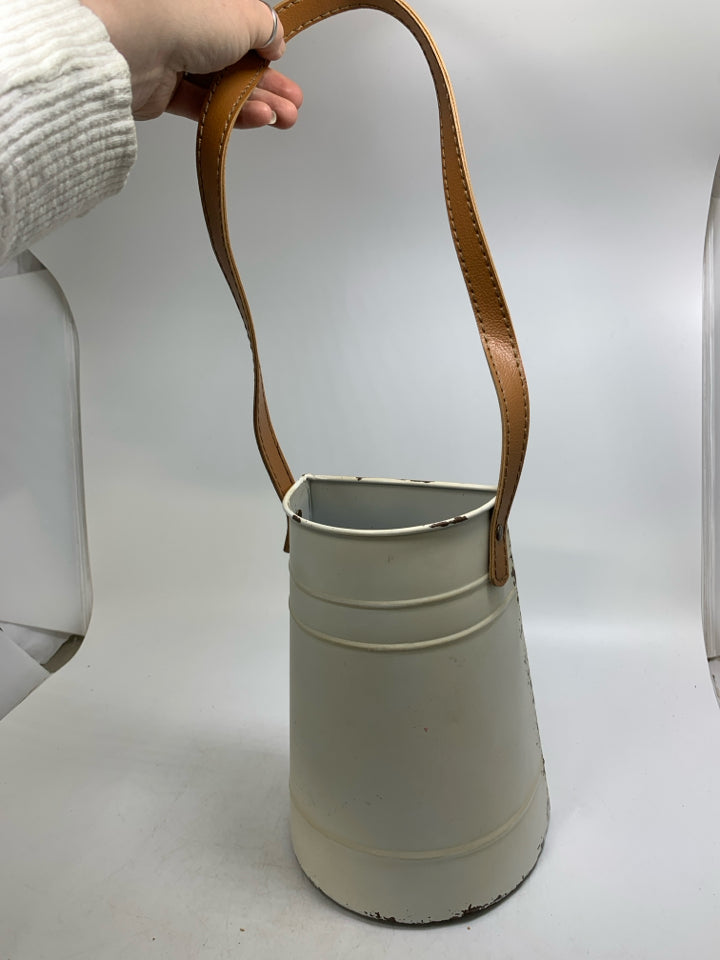 CREAM METAL HANGING PLANTER W/ FAUX LEATHER STRAP.