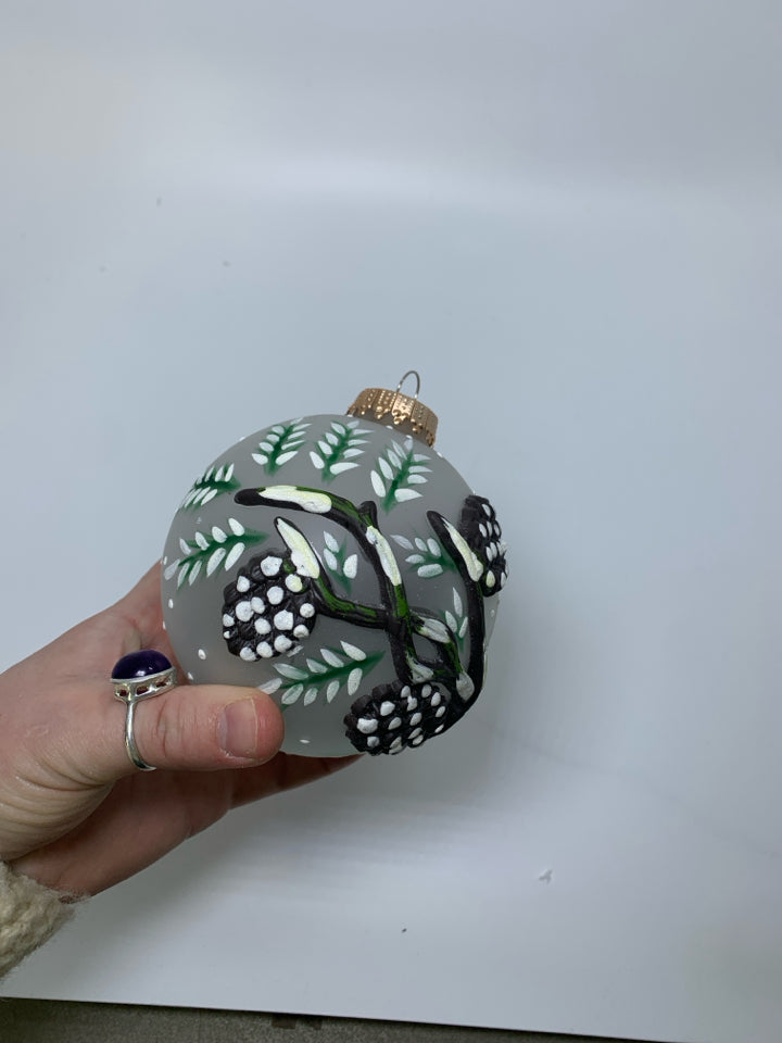 FROSTED GLASS BULB W/ EMBOSSED CARDINALS ORNAMENT.