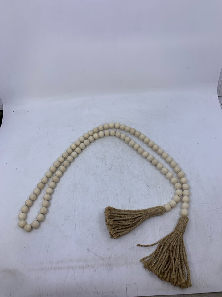 LIGHT WOOD BEADED W/ TASSELS.