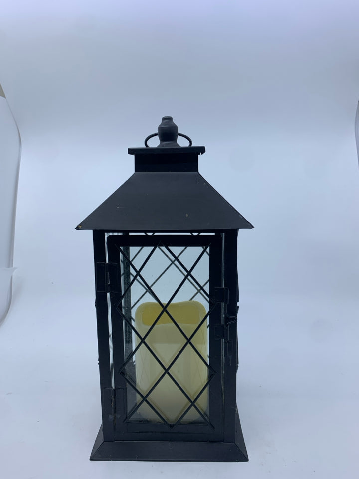 FLAMELESS CANDLE IN METAL LANTERN.