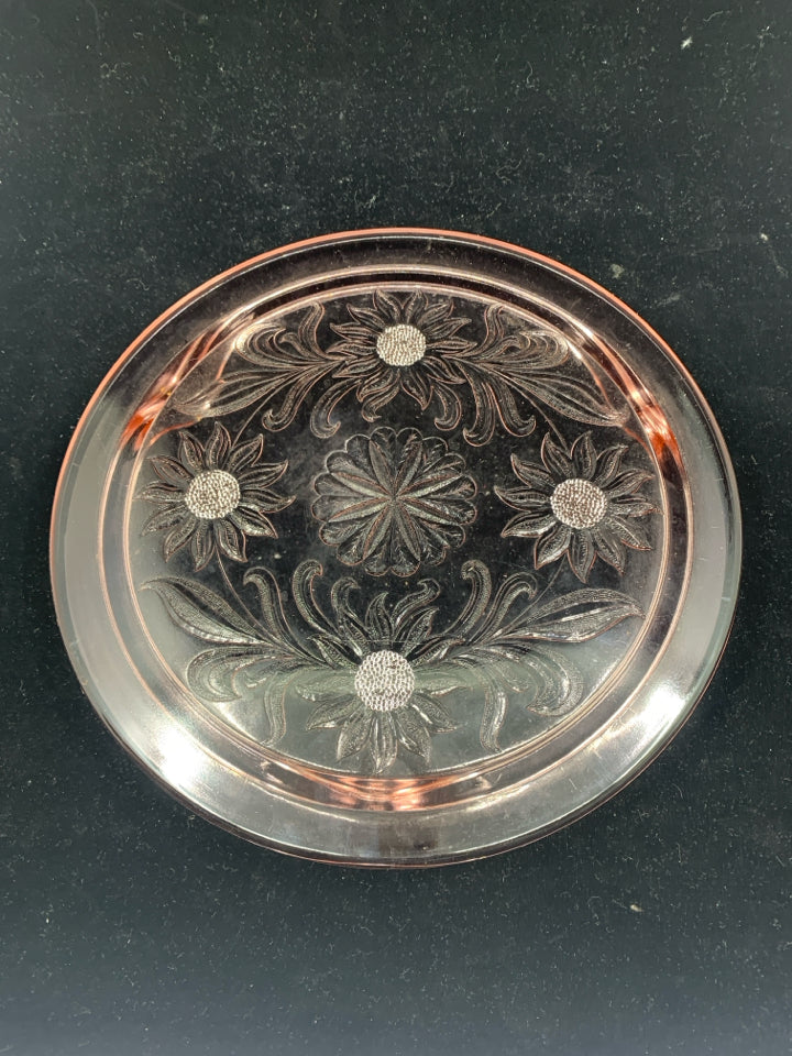 FOOTED PINK GLASS CIRCLE PLATTER W/ EMBOSSED FLOWERS.