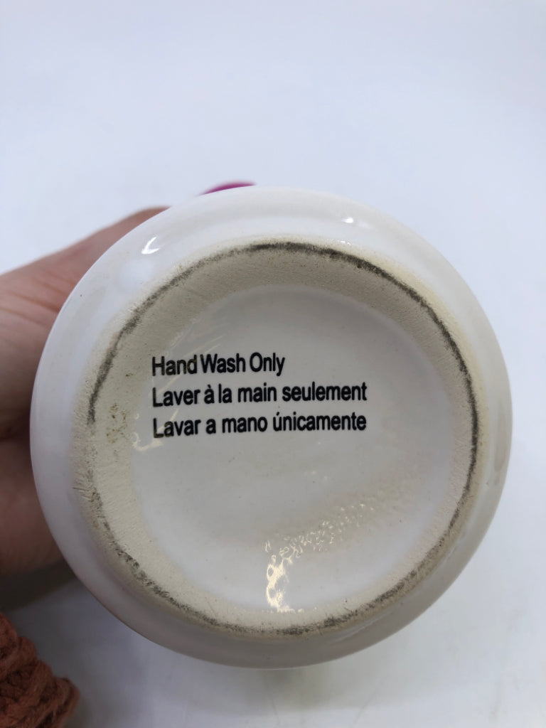 SMALL WHITE AND BLACK CANISTER W/ RED LID.