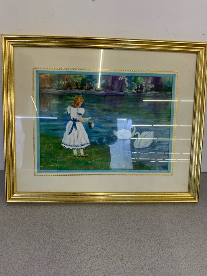 GIRL W/ BUCKET FEEDING SWANS WALL ART IN GOLD FRAME.