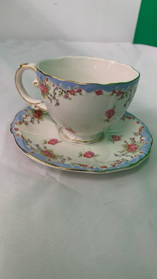 LIGHT BLUE W PINK FLORAL TEACUP AND SAUCER.