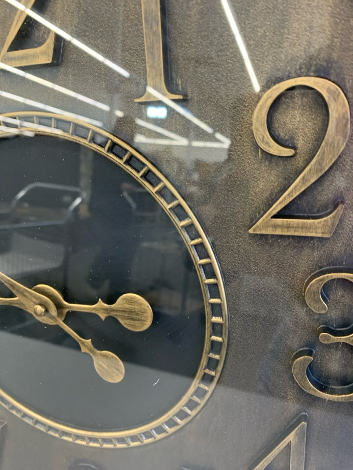 BLACK CLOCK W/BRASS PAINTED NUMBERS.