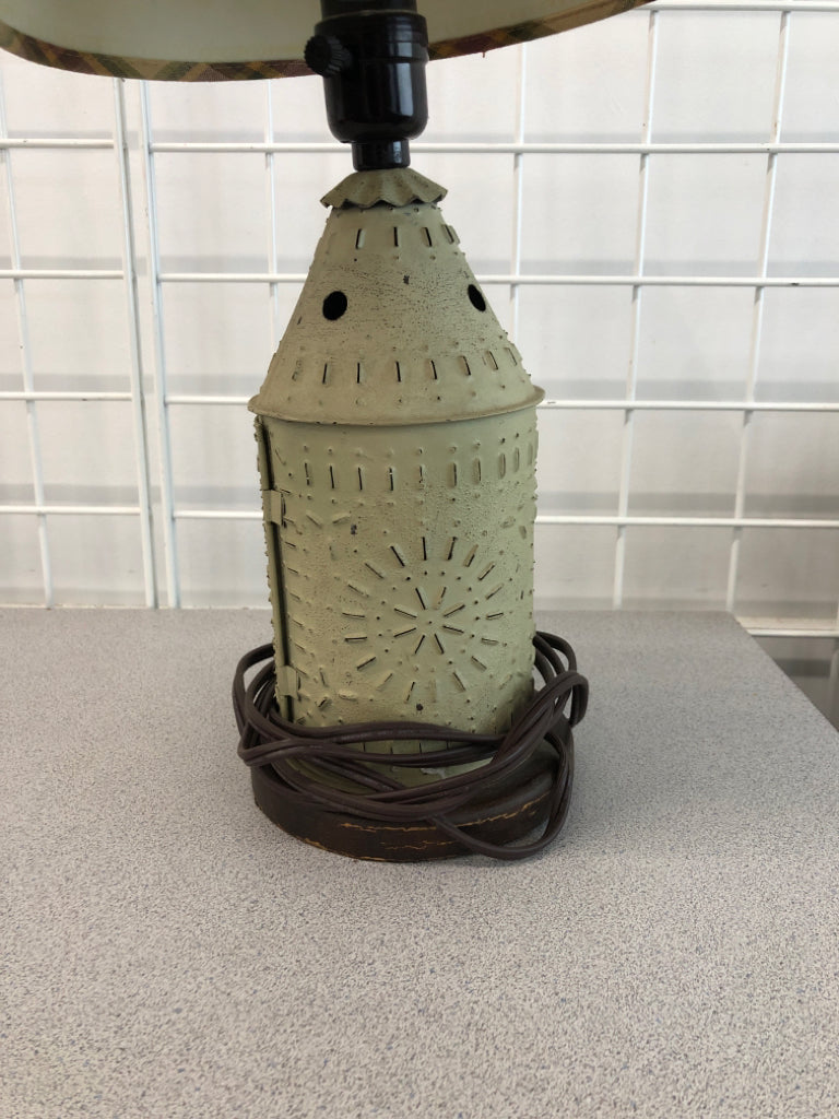 PUNCHED METAL PRIMITIVE LAMP W/PLAID SHADE.