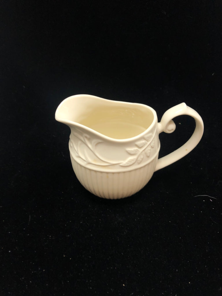 IVORY PITCHER EMBOSSED VINE LEAF PATTERN.