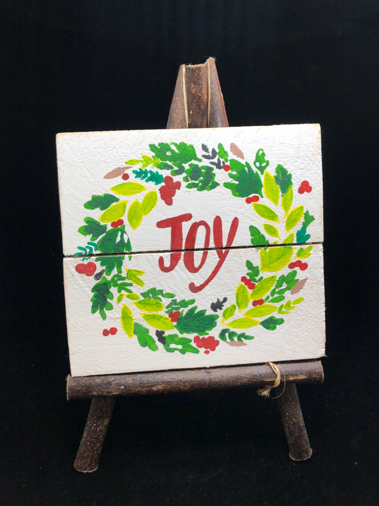 'JOY' WOOD SIGN ON BRANCHES.