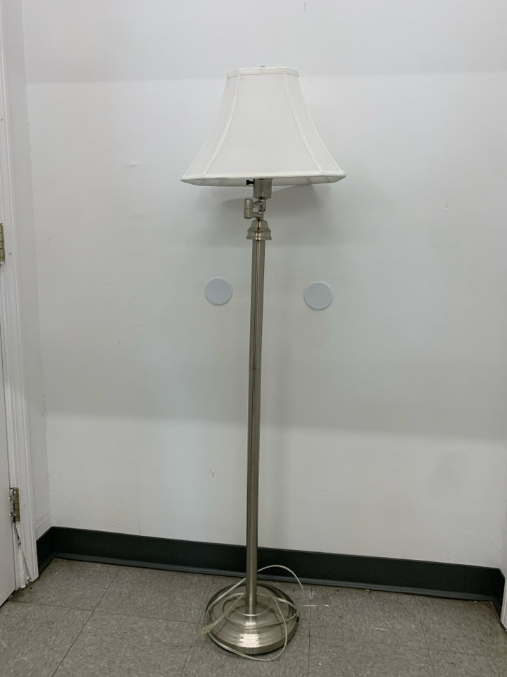 TALL SILVER FLOOR LAMP WITH WHITE SHADE.