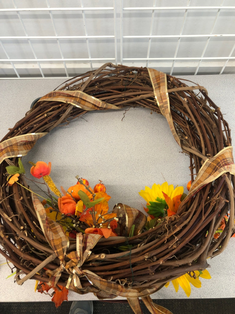 FAUX TWIG WREATH W/SUNFLOWERS AND PLAID BOW.