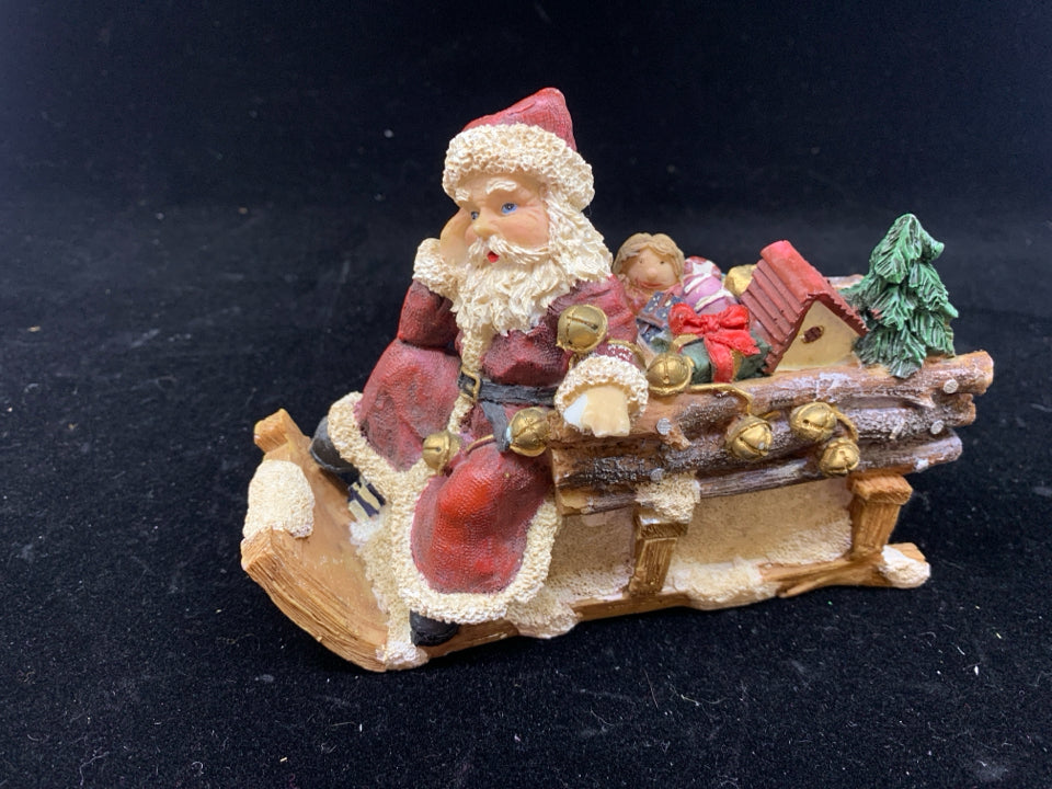 SANTA SITTING ON SLEIGH W TOYS.
