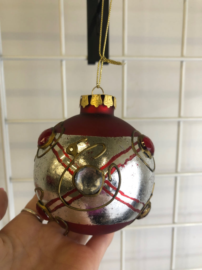 RED W/ SILVER BAND GLASS ORNAMENT W/ EMBOSSED JEWELS.