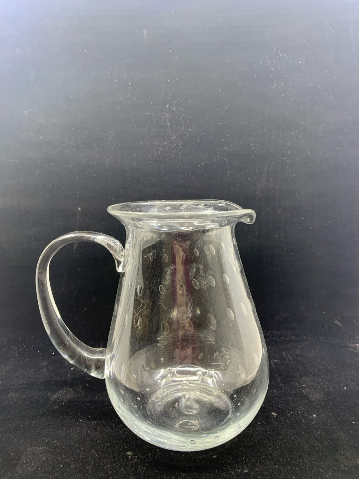 CLEAR GLASS PITCHER W/ CIRCLE DESIGNS.