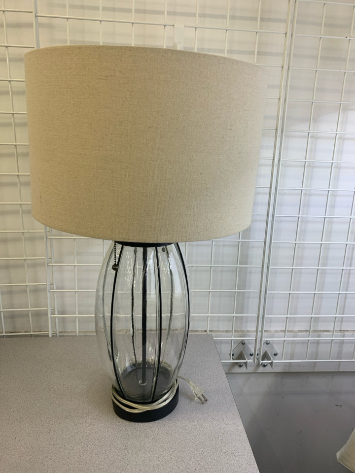 GLASS BASE LAMP W/TAN SHADE.