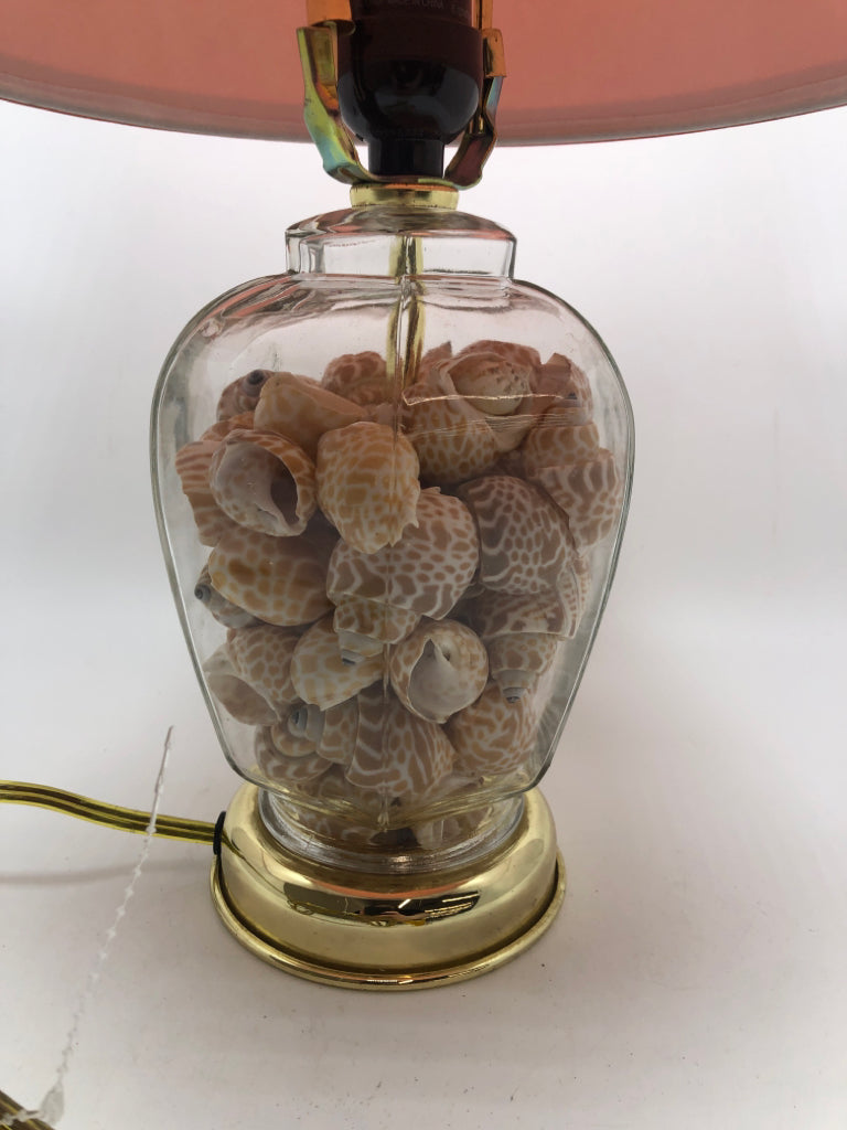 SEASHELL FILLED LAMP W/ORANGE SHADE.