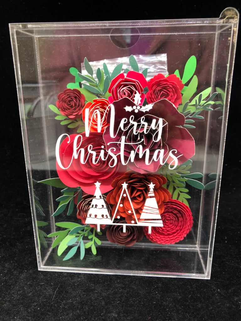 CLEAR PLASTIC SHADOW W/ ROLLING PAPER FLOWERS MERRY CHRISTMAS.