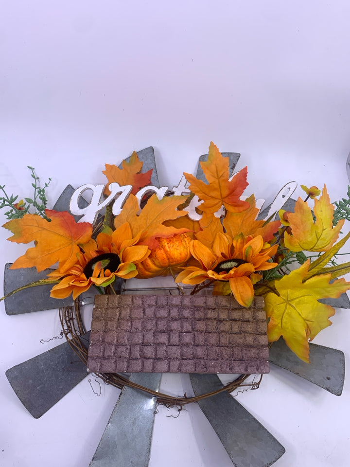 GRATEFUL METAL SUN WREATH W/ ORANGE LEAVES.