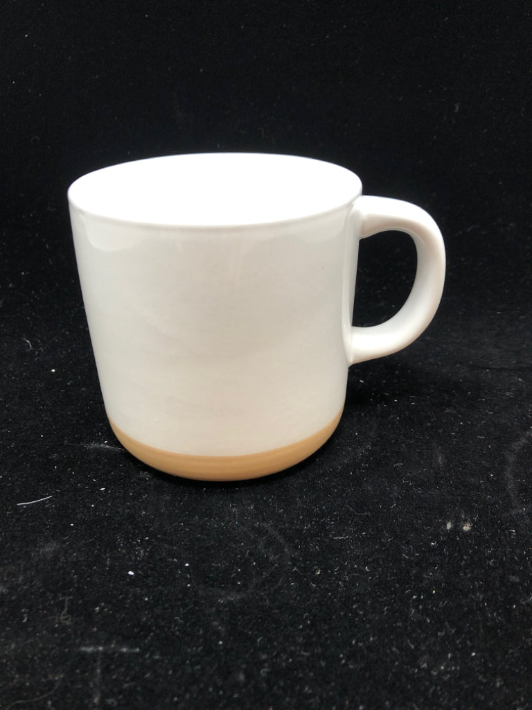 WHITE MUG W/BEIGE BOTTOM.