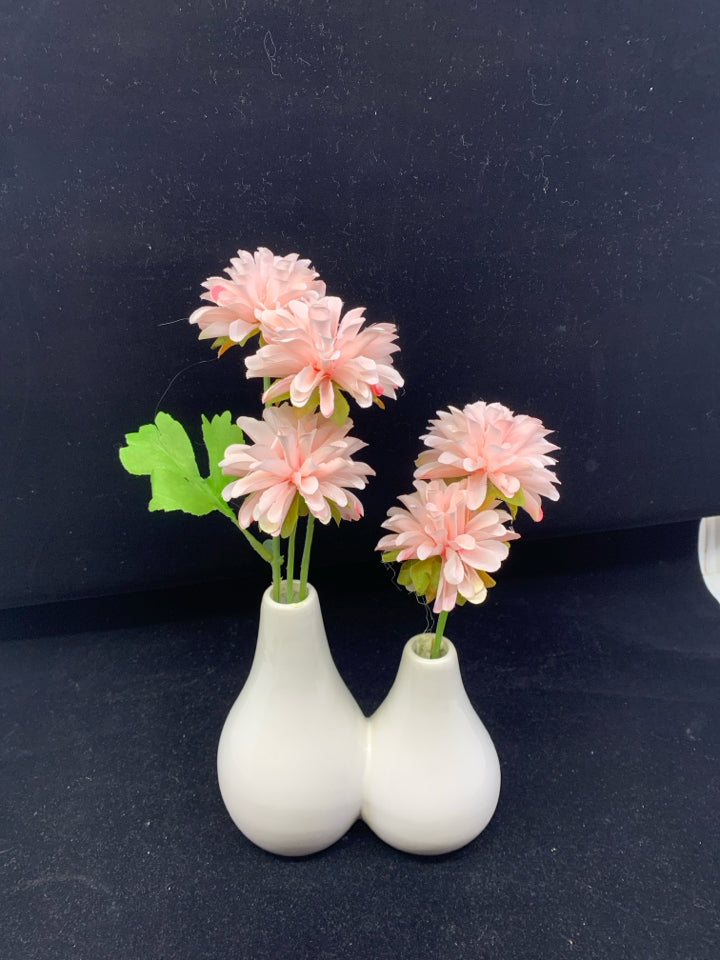 FAUX PINK FLORAL IN WHITE CONNECTED VASES.