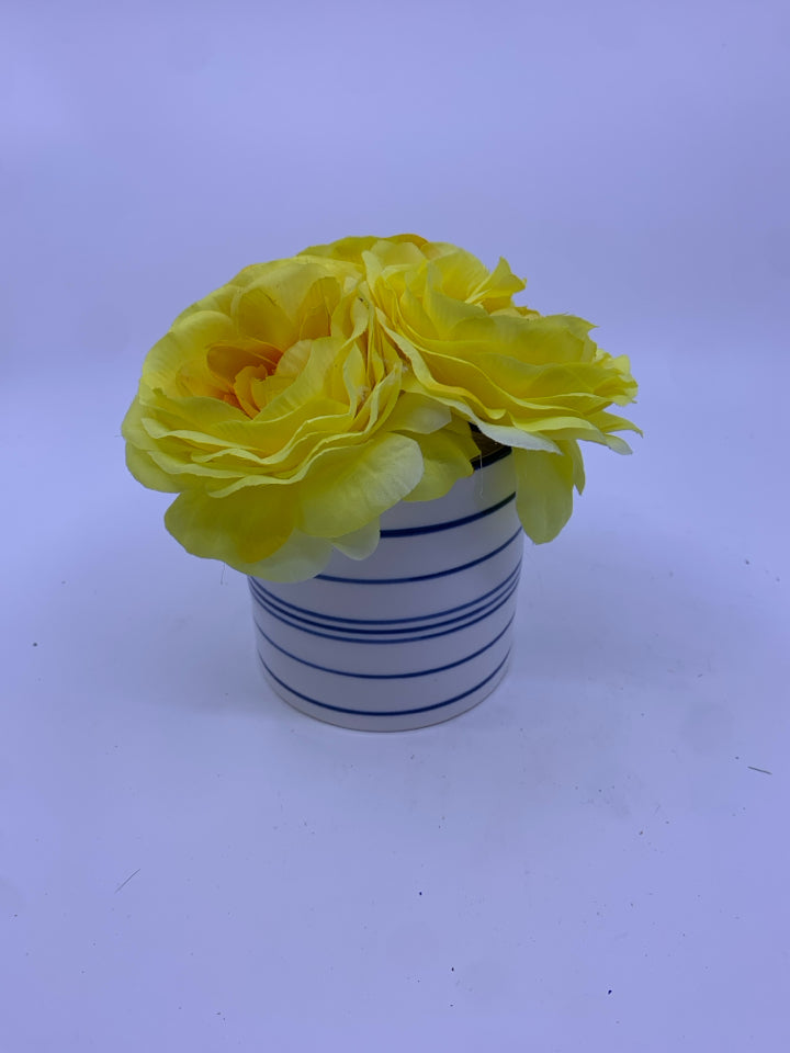 YELLOW FLORAL IN BLUE AND WHITE VASE.