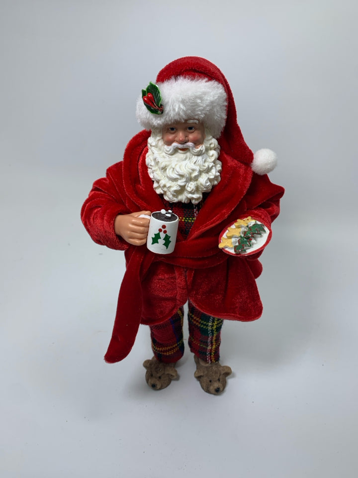 STANDING SANTA IN PJS HOLDING COCOA & COOKIES.