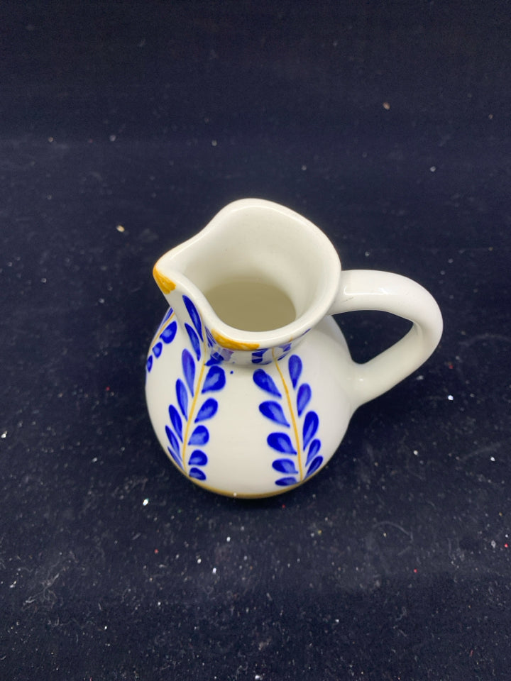 YELLOW AND BLUE FLORAL CREAMER.