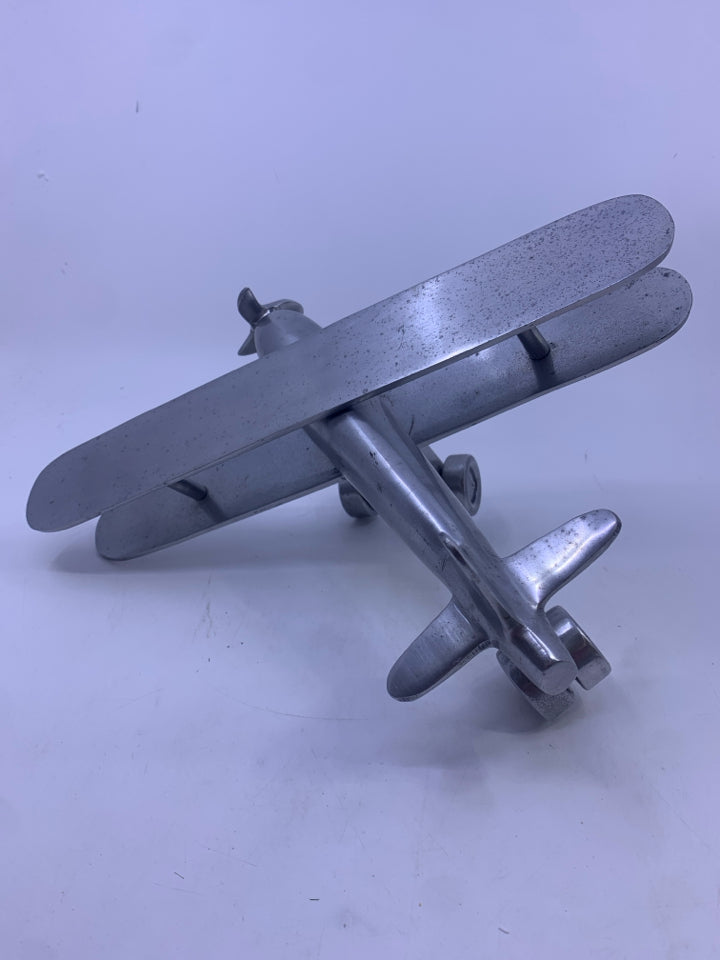 MATTE SILVER METAL AIRPLANE W/ MOVABLE WINGS.