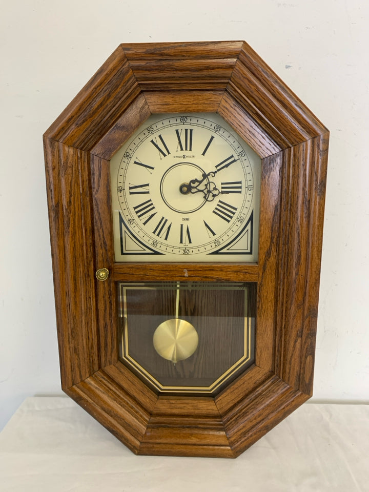 HOWARD MILLER WOOD HANGING CLOCK.