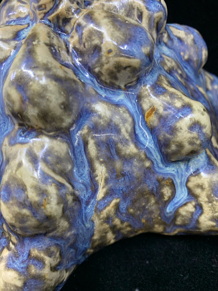 CERAMIC ART WITH TEXTURED BLUE AND BROWN GLAZE.