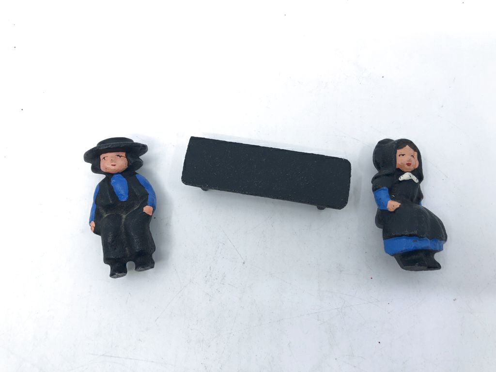 3PC CAST IRON AMISH COUPLE SITTING ON BENCH.