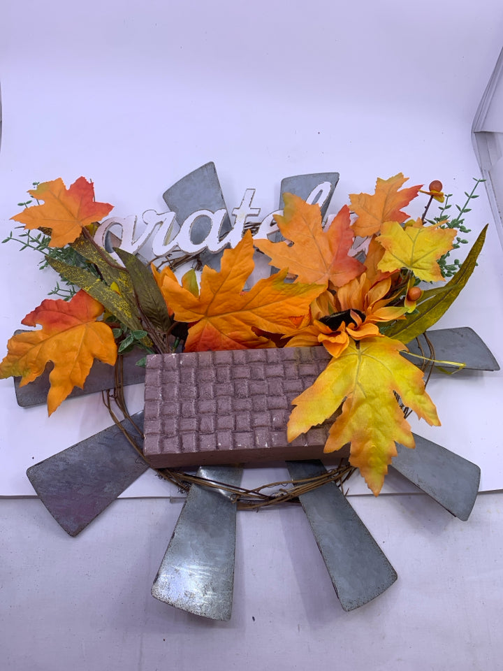 GRATEFUL METAL SUN WREATH W/ ORANGE LEAVES.