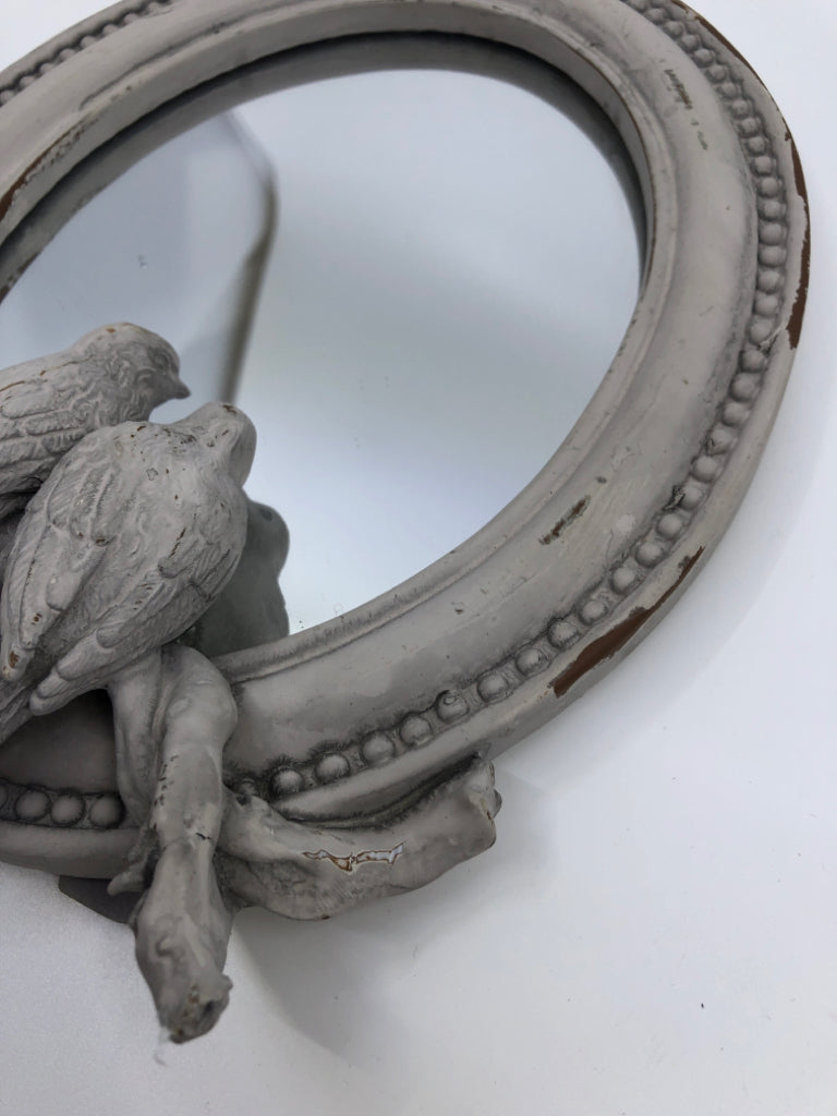 SMALL DISTRESSED OVAL MIRROR W/ EMBOSSED BIRDS.