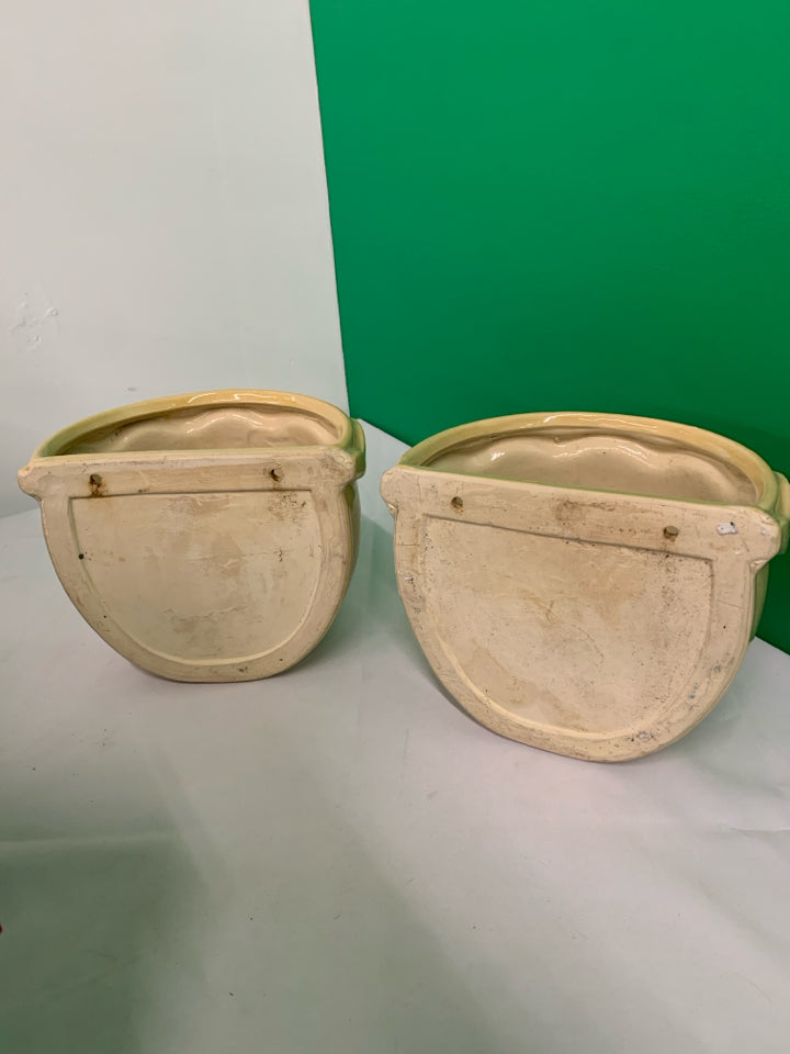 2 TAN CERAMIC WALL HANGING PLANTERS.