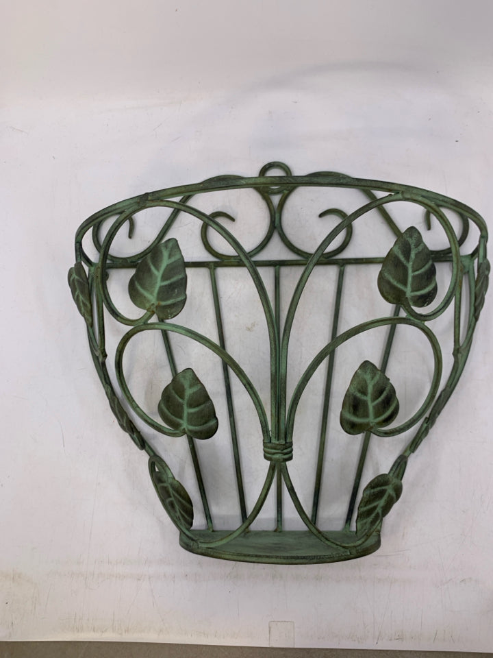 GREEN METAL WALL POCKET W/ LEAVES.