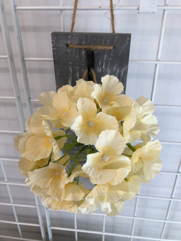 HANGING MASON JAR VASE W/FLORALS & GRAY WOOD BACK.