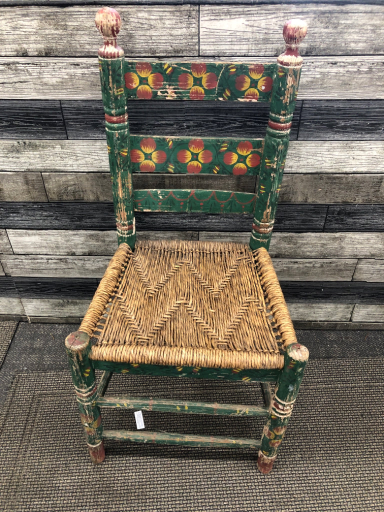 VTG GREEN W RED FLORAL DISTRESSED AND WICKER SEAT CHAIR.