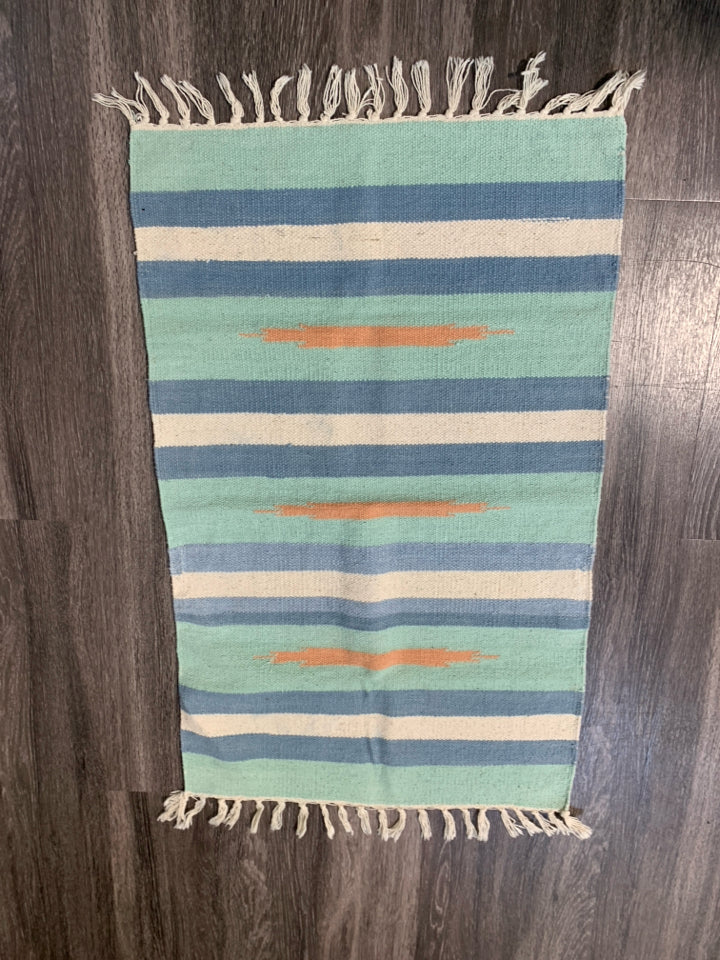 ASSORTED COLORS WOVEN AZTEC PATTERN RUG W/ TASSELS.