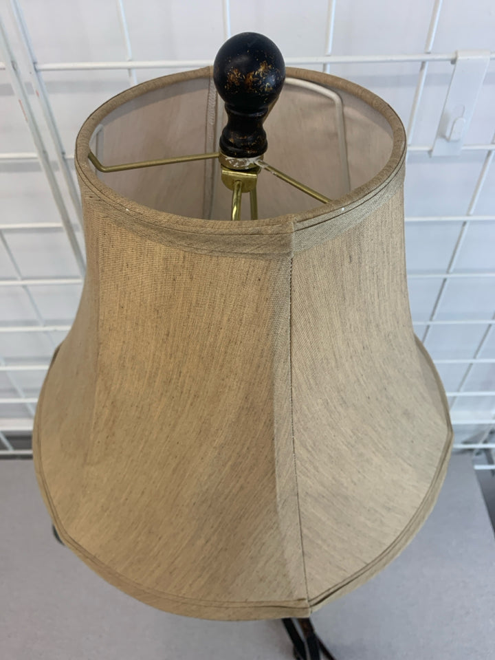 BLACK SCROLL BASE LAMP W/GOLD FLECKS AND TAN SHADE.