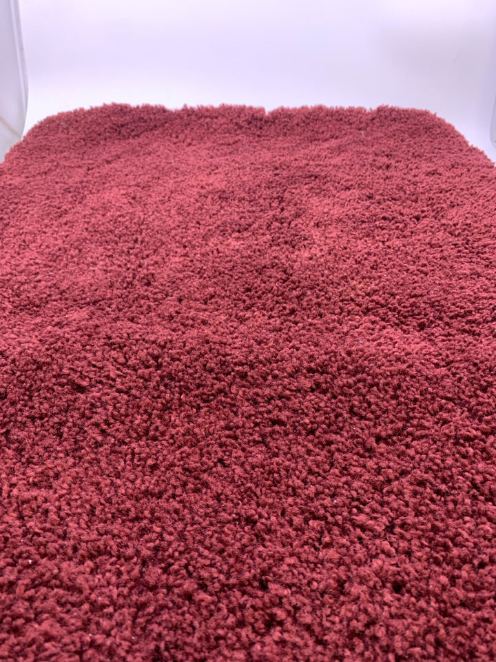 RED BATH MAT.