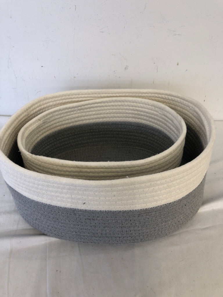 2 GREY AND WHITE OVAL NESTING BASKETS.