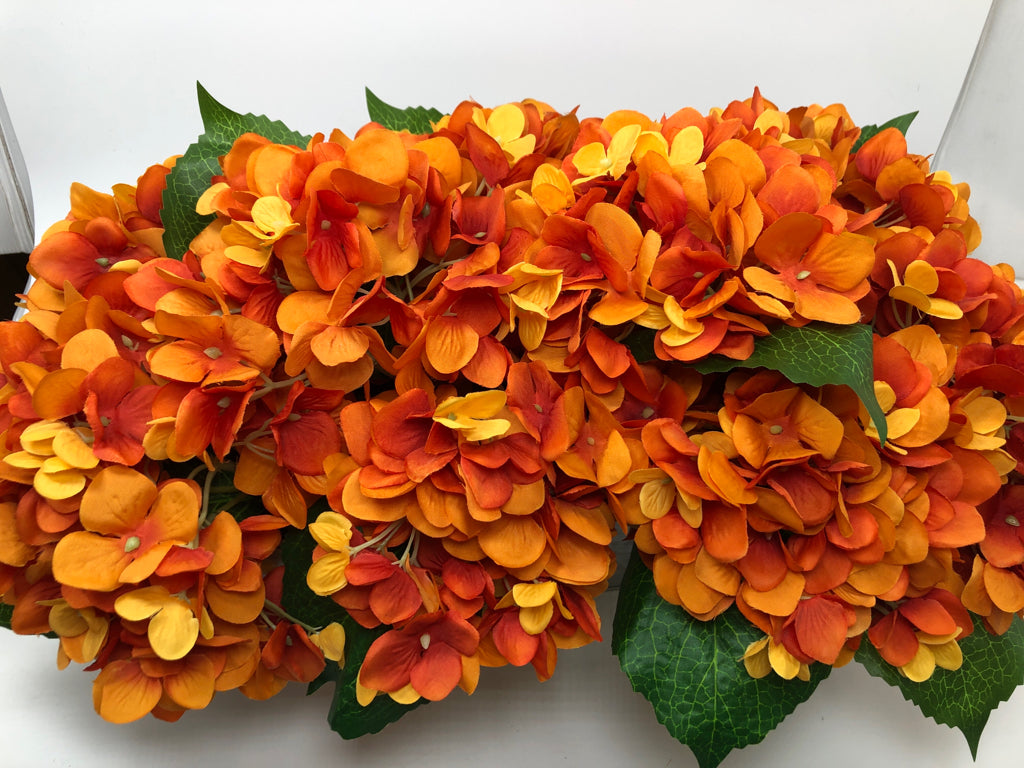 FAUX ORANGE HYDRANGEAS IN TIN PLANTER.