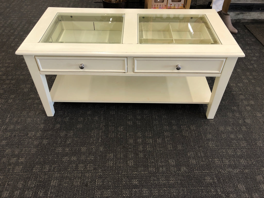 CREAM COFFEE TABLE W GLASS TOP AND 2 DRAWERS.