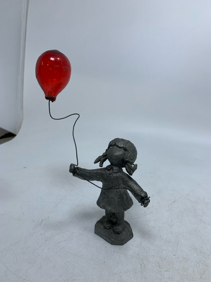GIRL HOLDING BALLOON FIGURINE.