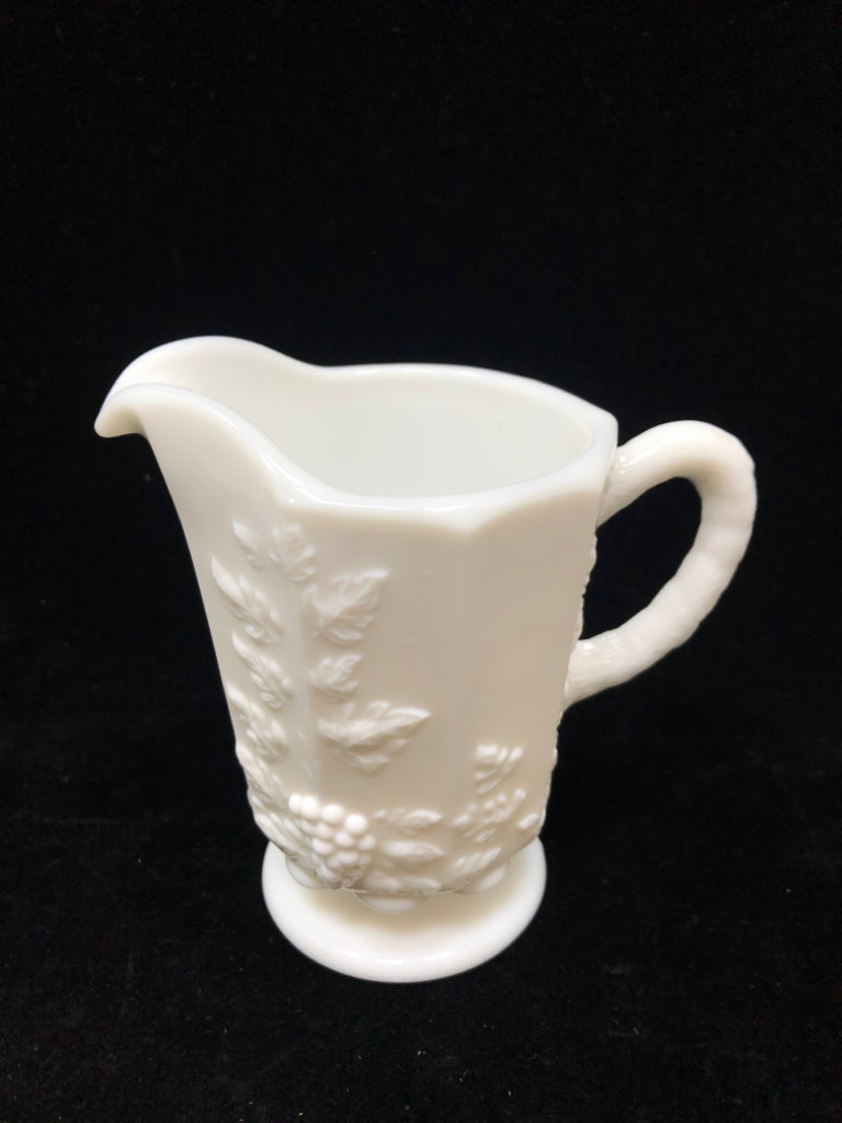 VTG MILK GLASS PITCHER W/EMBOSSED FLORAL DESIGNS.