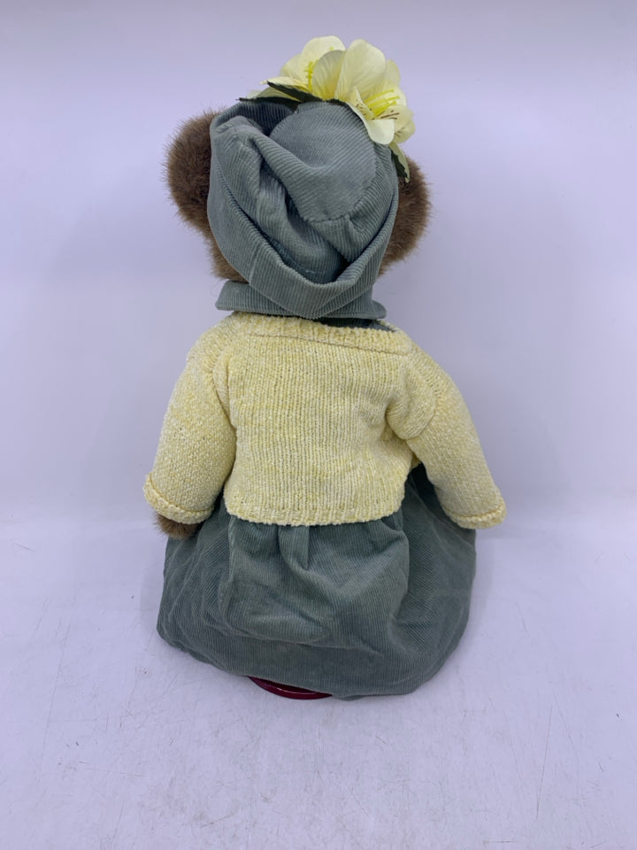 BROWN BEAR W/ LIGHT GREEN DRESS/HAT & YELLOW SHALL ON STAND BOYDS BEAR.
