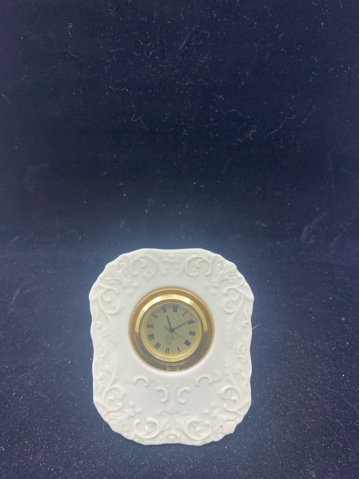 SMALL LENOX STANDING CLOCK W/ EMBOSSED SCROLL PATTERN.