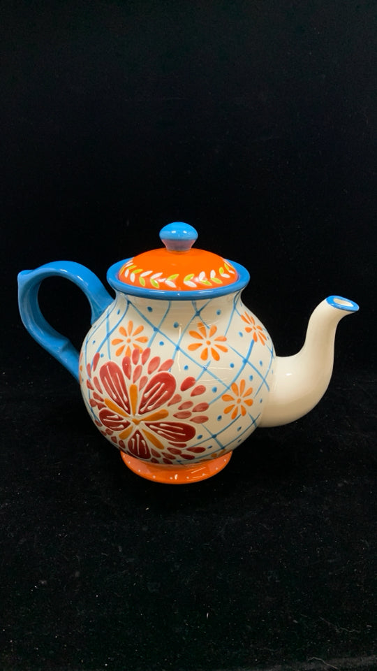 COLORFUL FLORAL TEAPOT W/BLUE HANDLE.