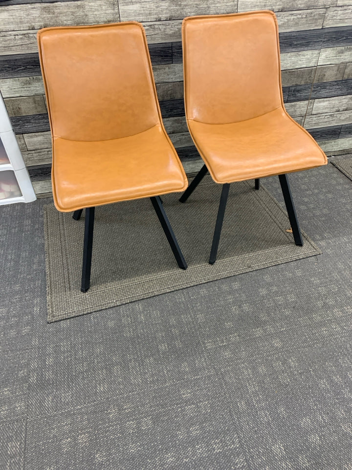 2 CARMEL COLORED FAUX LEATHER ACCENT CHAIRS W/ BLACK METAL LEGS.