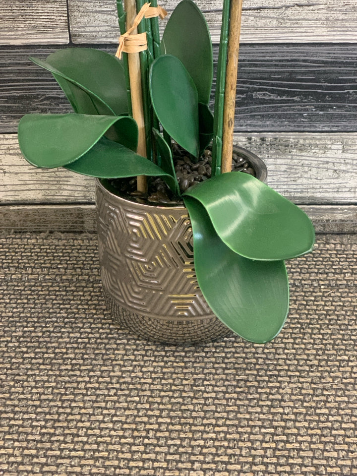 FAUX WHITE ORCHID W FAUX PEBBLES IN METAL VASE.